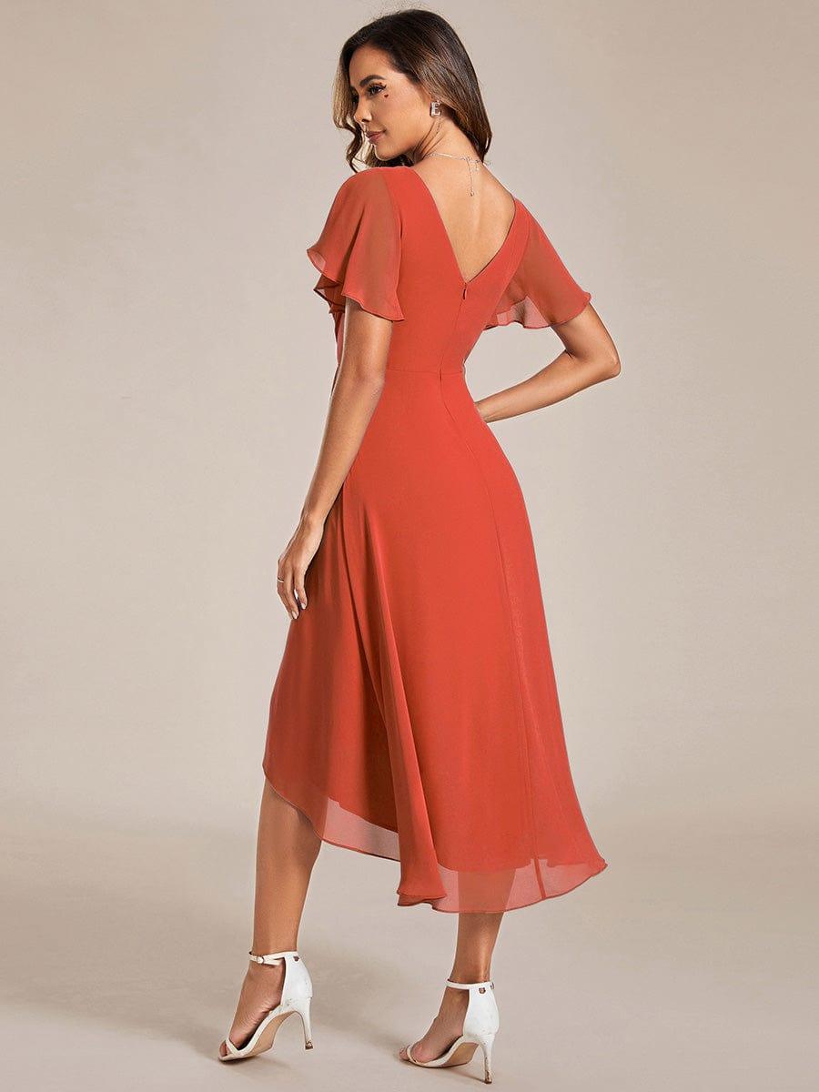 Back view of the burnt orange chiffon dress, showing the V-shaped back, zip and sheer layered high-low skirt. 93