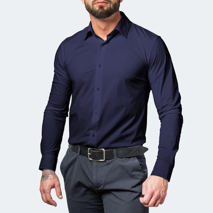 Front view of a muscular, bearded model in a navy blue buttoned shirt, grey trousers and a black leather belt. 5