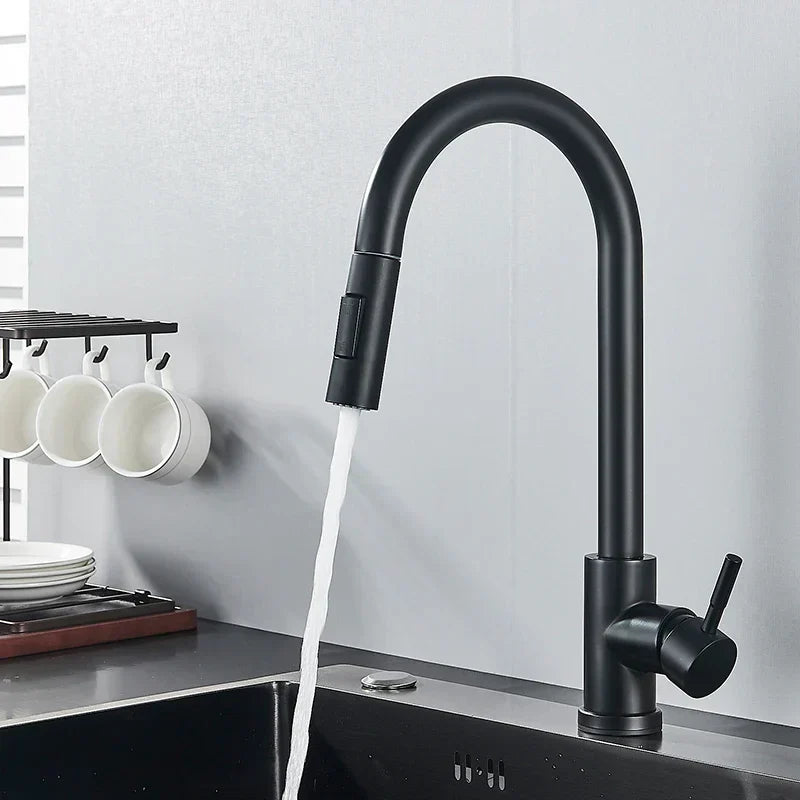 Matt black kitchen tap with an arched spout and side lever, water pouring from the spray head into a dark sink. 5