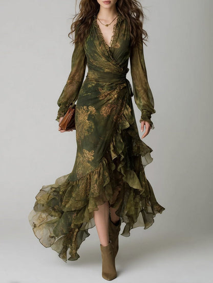 Full-length front view of a model in the green floral wrap dress with sheer sleeves and tiered ruffled hem, worn with khaki ankle boots. 1
