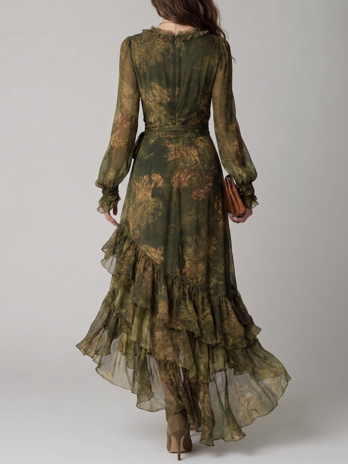 Back view of the dress on a model, showing the concealed zip, ruffled neckline, waist tie and cascading asymmetric ruffle tiers. 2
