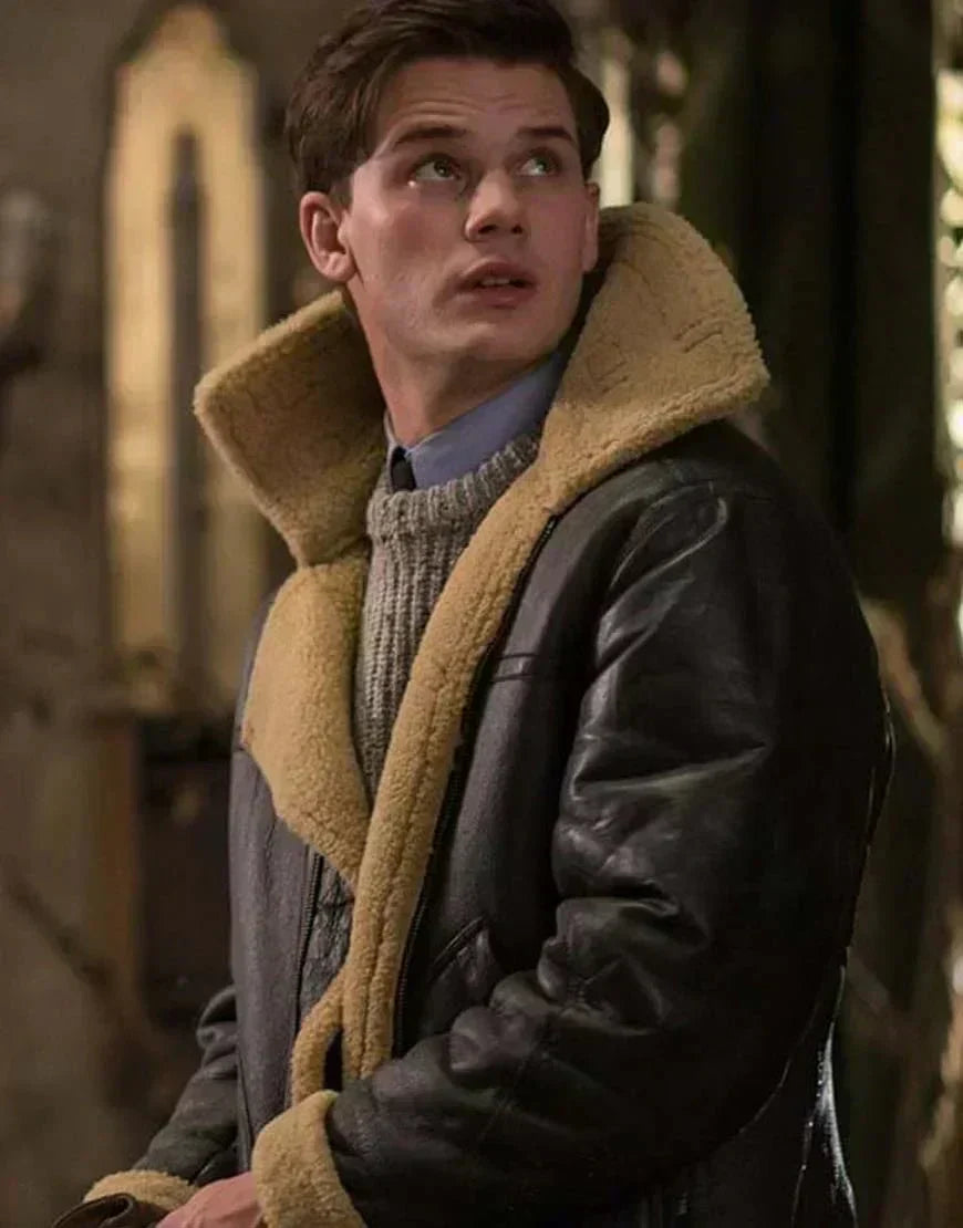 Young man looking upwards, wearing the leather jacket with its tall shearling collar over a knit jumper 5