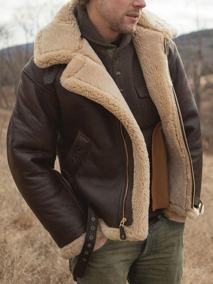 Outdoor view of the jacket worn open, showing cream shearling lining, gold zip and buckled waist strap 8