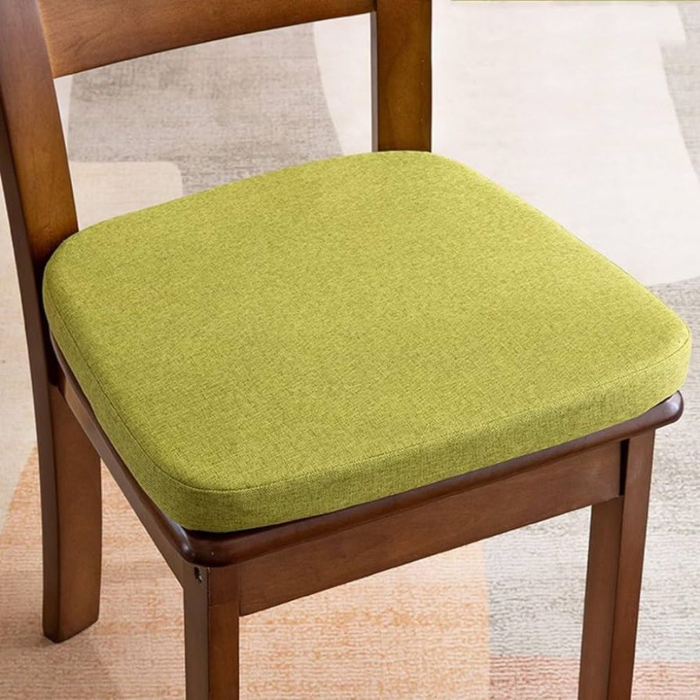 Lime green woven-fabric seat cushion with rounded corners, resting on a dark wooden dining chair 1