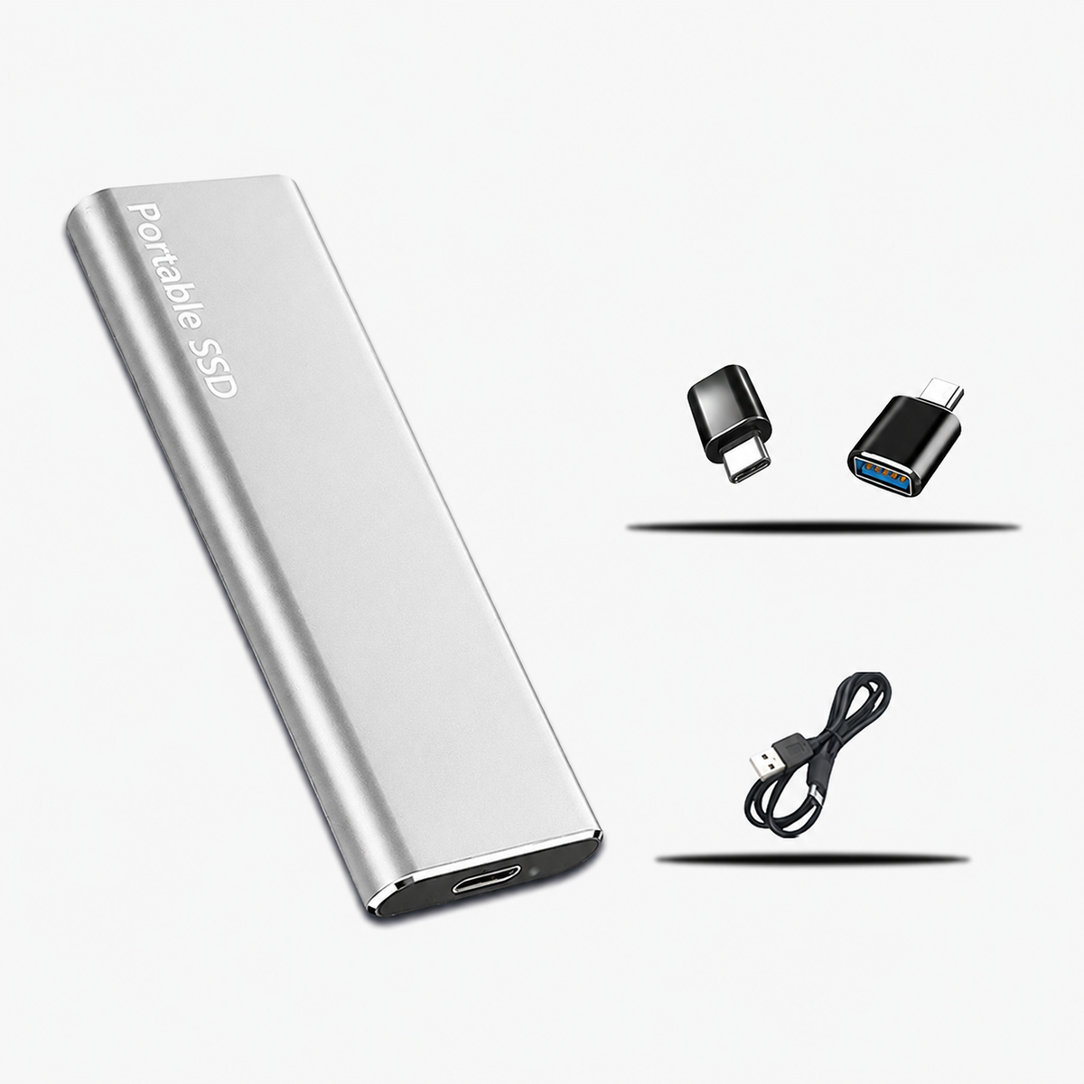 Silver slim drive pictured with two black adapters and a black USB cable beside it 4