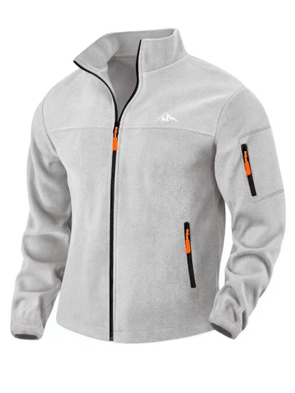 Front view of the light grey fleece jacket with stand collar, full zip, orange zip pulls and a zipped sleeve pocket. 3