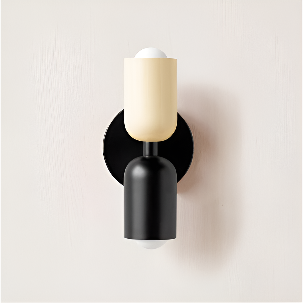 Wall light with a cream upper head and black lower head on a round black backplate. 31