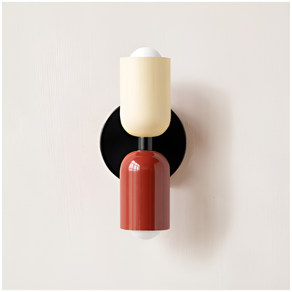 Wall light with a cream upper head and red lower head on a round black backplate. 30