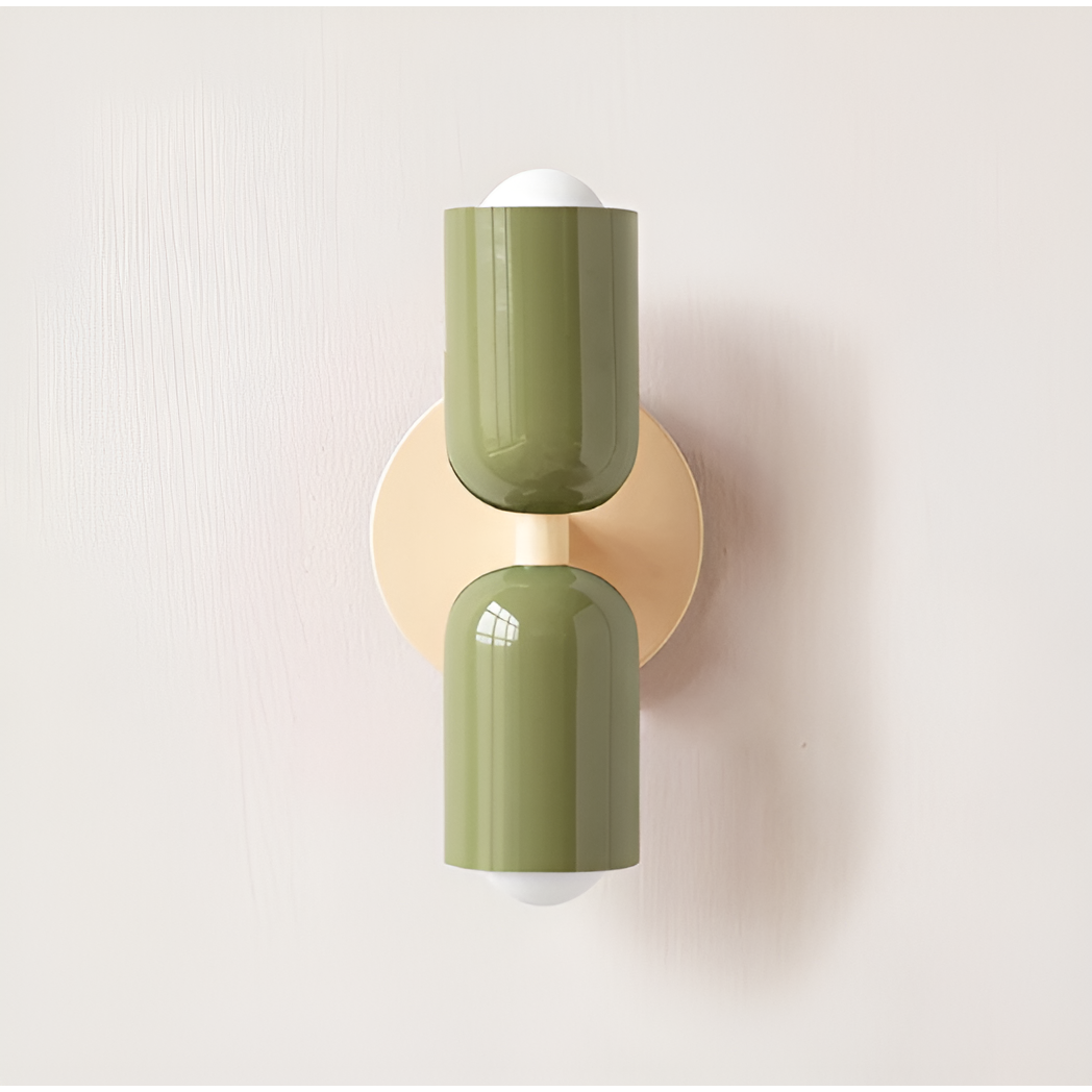 Close front view of a wall light with two green heads on a cream round backplate. 16