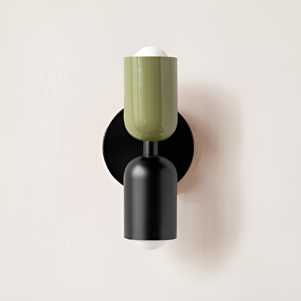 Wall light with a green upper head and black lower head on a round black backplate. 29