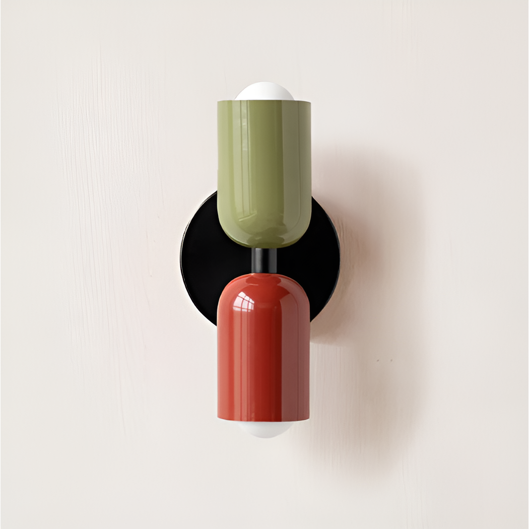 Wall light with an olive green upper head and red lower head on a black backplate. 28