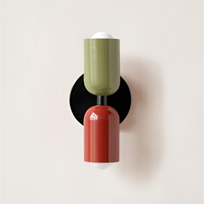 Wall light with an olive green upper head and red lower head on a black backplate. 28