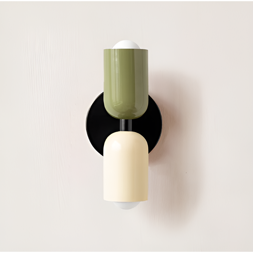 Wall light with a green upper head and cream lower head on a round black backplate. 21