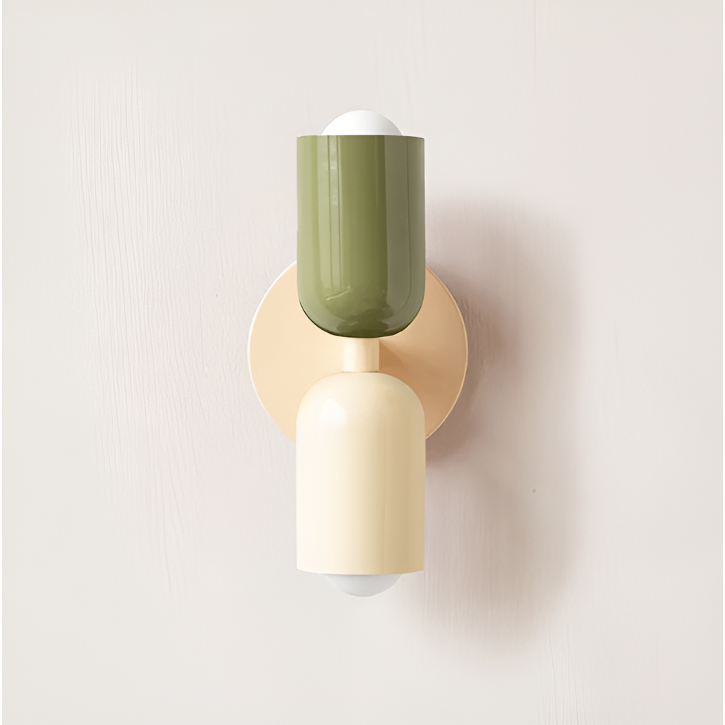 Wall light with a green upper head and cream lower head on a cream round backplate. 26
