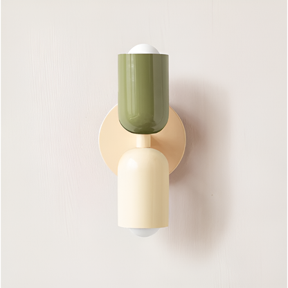 Wall light with a green upper head and cream lower head on a cream round backplate. 26
