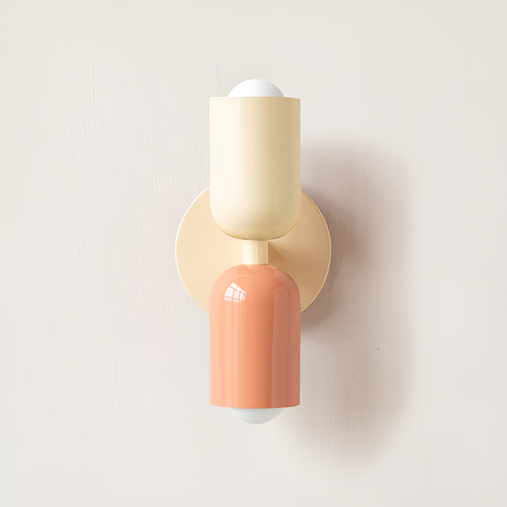 Wall light with a cream upper head and peach lower head on a cream round backplate. 24