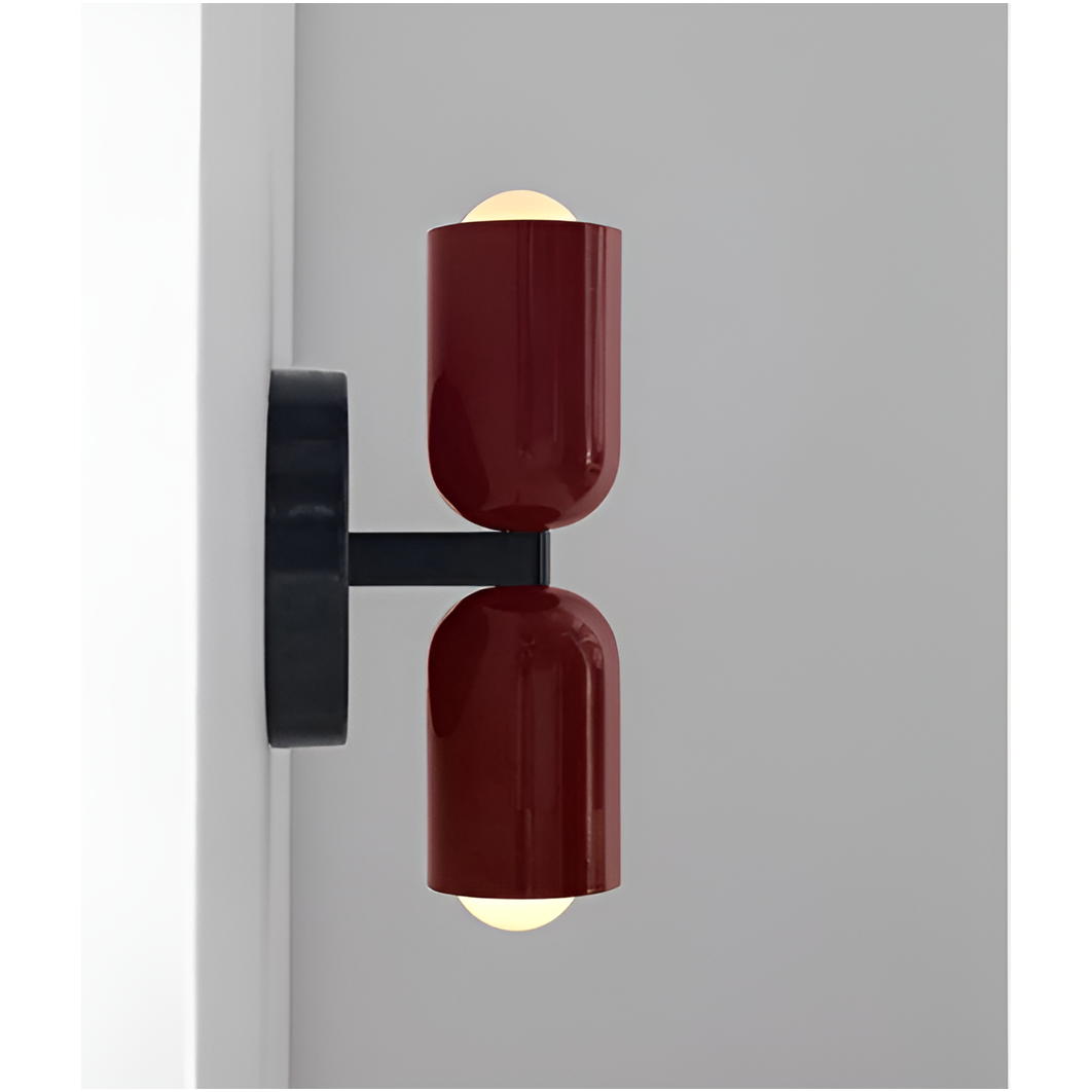 Side view of a wall light with two deep red heads on a black arm, showing how far it projects from the wall. 17