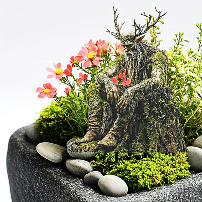 Antlered woodland spirit on a mossy stump among pink flowers, green moss and pale pebbles in a grey planter. 9