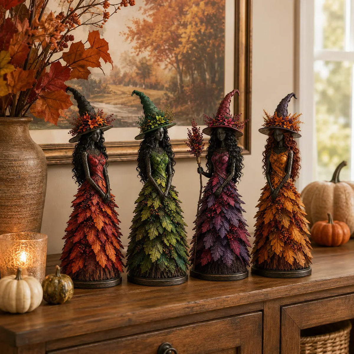 All four witch figurines in red, green, purple and golden-orange standing in a row on a wooden sideboard with pumpkins and a candle. 7