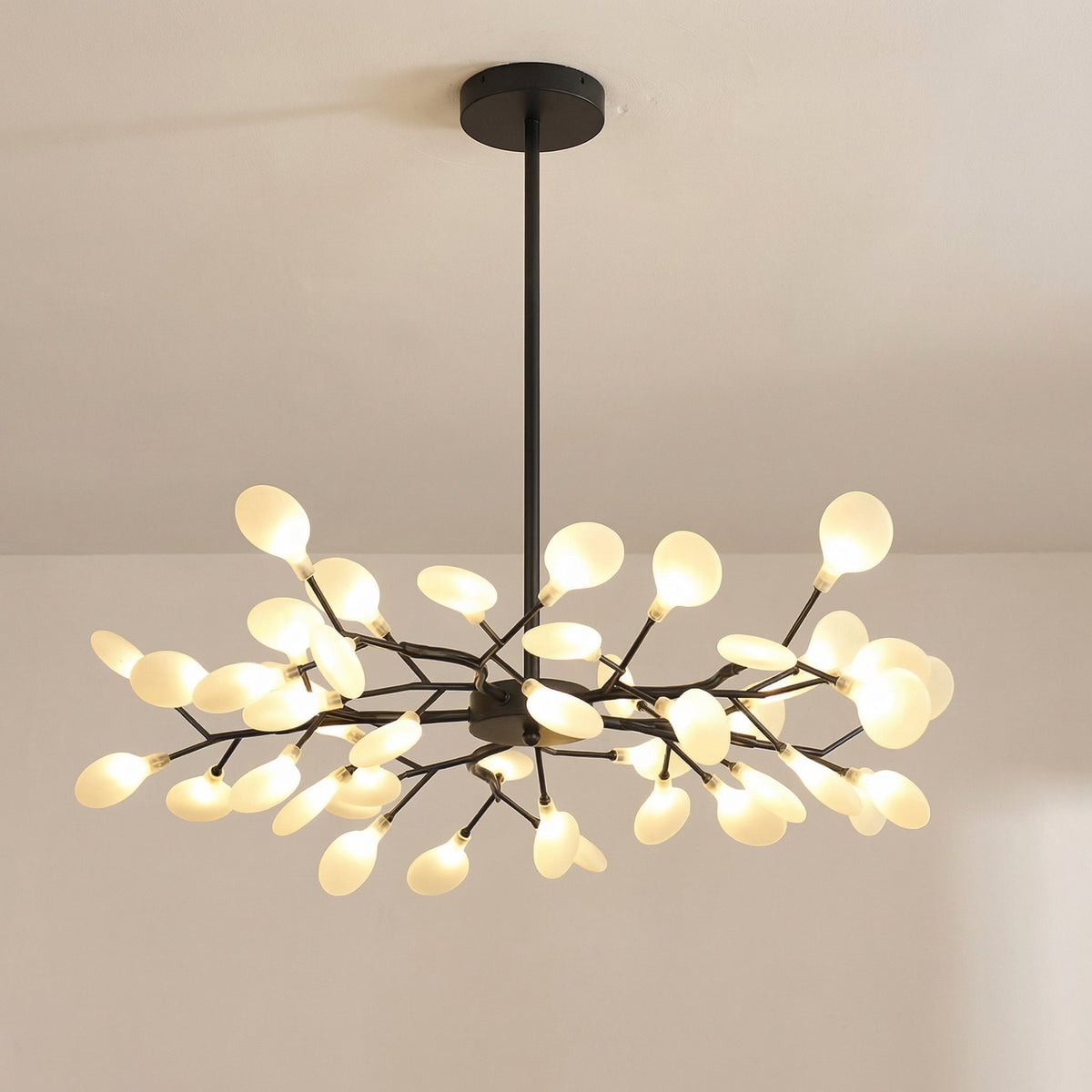 Larger black chandelier with many leaf-shaped glowing orbs on thin branches, seen from slightly below 8
