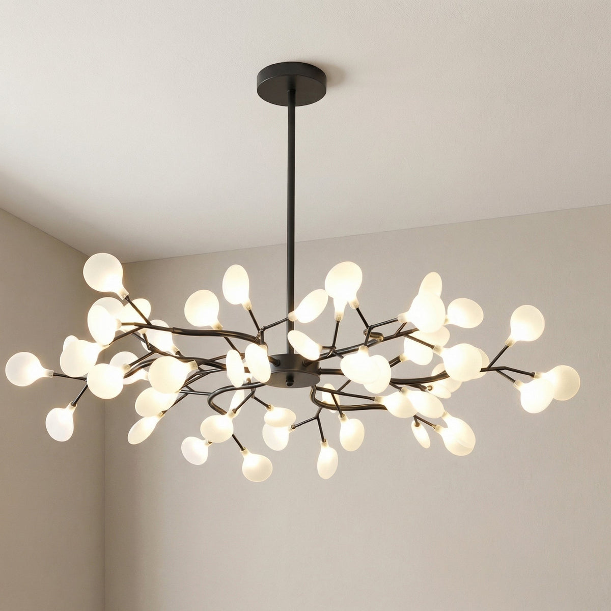 Large black branch chandelier with glowing frosted orbs, photographed in a room corner at an angle 10