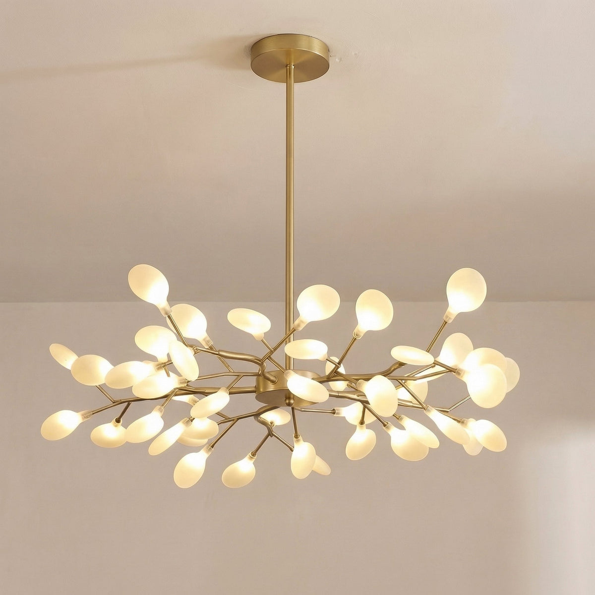 Larger gold chandelier with many leaf-shaped glowing orbs on slender branches, seen from slightly below 9
