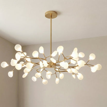 Large gold branch chandelier with glowing frosted orbs, photographed in a room corner at an angle 11