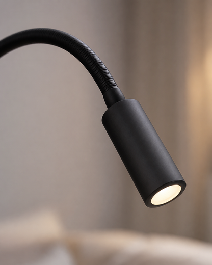 Close-up of the black spotlight head and ribbed flexible arm, softly lit against a blurred neutral background. 4