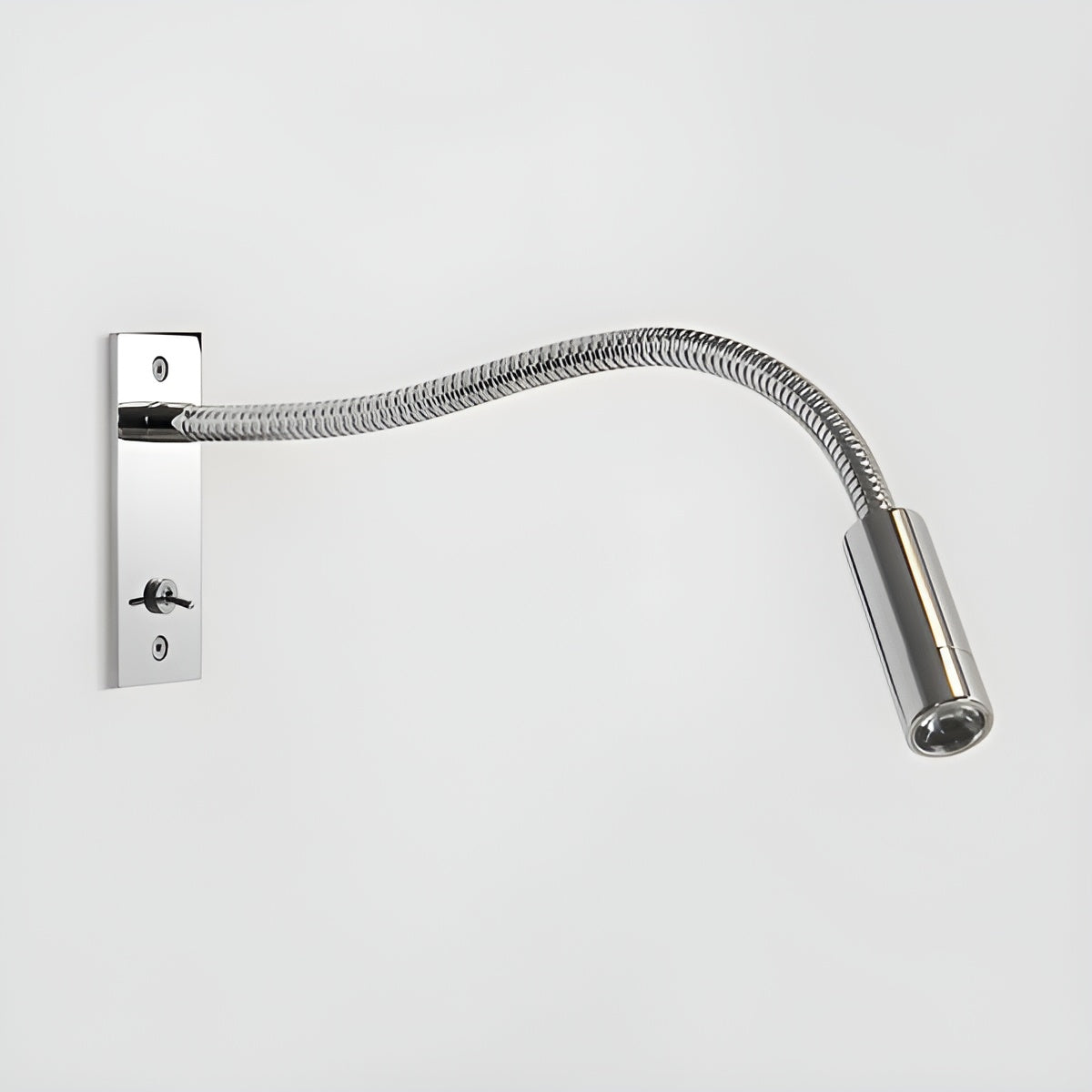 Polished chrome version of the flexible wall light, with shiny backplate, toggle switch, ribbed arm and cylindrical spotlight head. 12