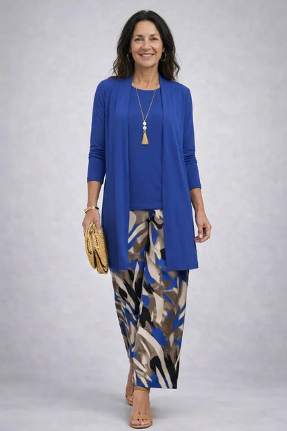 Smiling model in a plain royal blue cardigan and tee with brush-stroke printed wide trousers 2