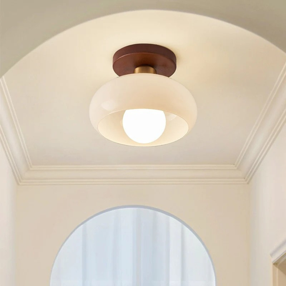 Smaller version of the light glowing in a hallway with a moulded arched ceiling 3