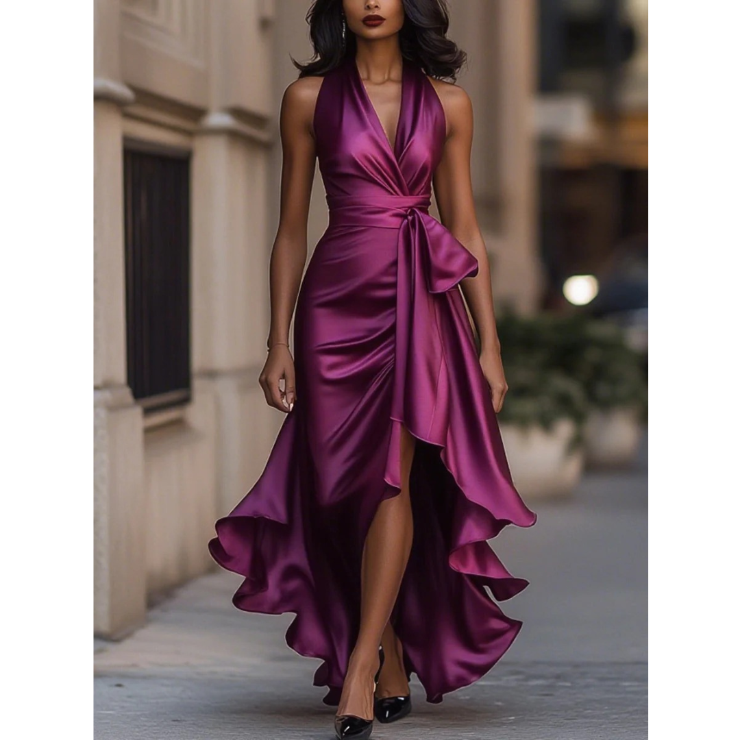 Front view on a model of the satin halter dress in magenta purple, with gathered waist and flowing hem. 6