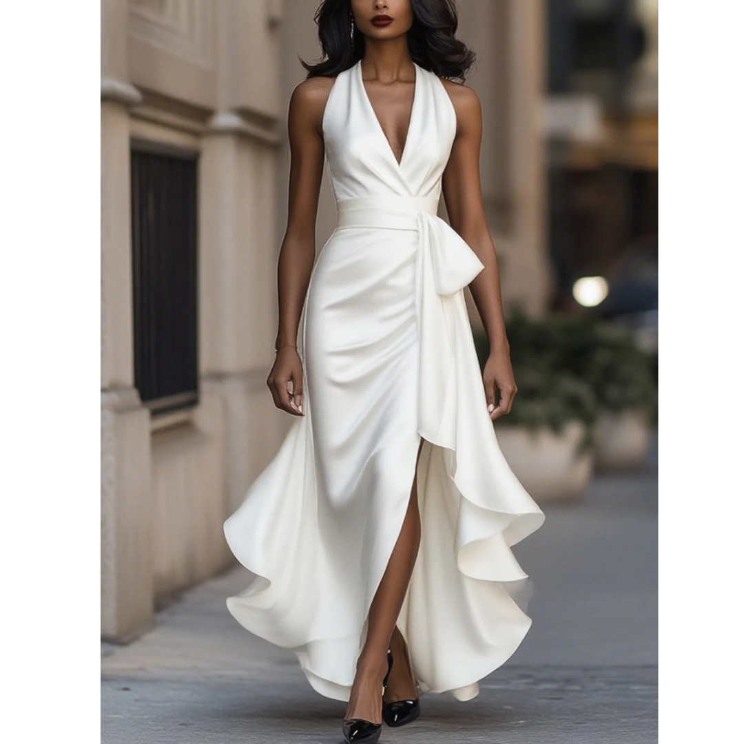 Front view on a model of the satin halter dress in white, with plunging draped neckline and side-split ruffled skirt. 3