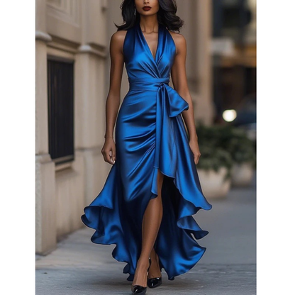 Front view on a model of the glossy satin halter dress in royal blue, with bow at the waist. 4