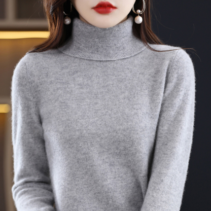 Light grey marl roll-neck jumper on a model, showing the textured soft knit and tall ribbed collar. 11