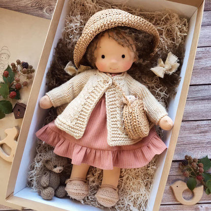 Doll with dark curly hair in woven straw hat, cream cardigan, pink ruffled dress and crossbody bag, boxed with a small teddy 8