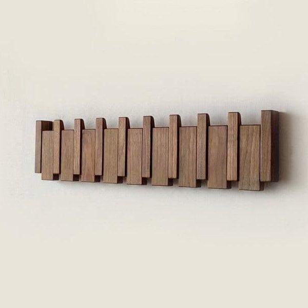 Front view of the dark walnut-toned rack with all hooks folded flat against the wall 4
