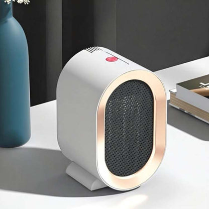 White heater with rose-gold rim and red power button on a white desk beside a vase and books 6