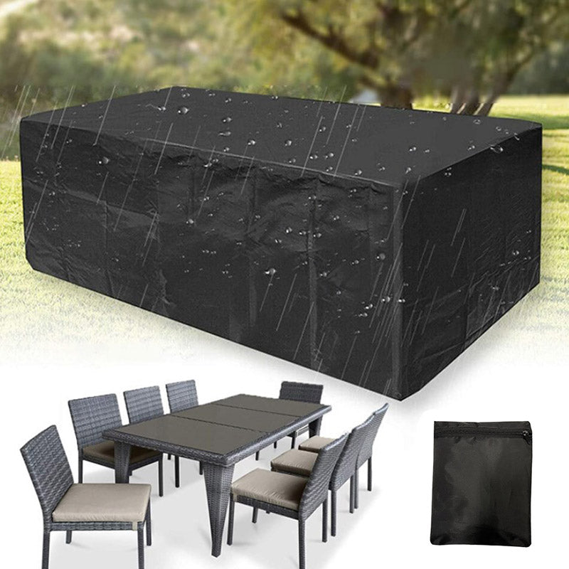 Black cover beaded with raindrops over a garden table, with a rattan dining set and the small black storage bag below. 6