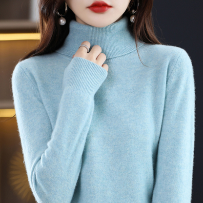 Pale sky-blue marl roll-neck jumper worn by a model, hand at the collar, showing the ribbed cuff and soft fluffy knit. 4