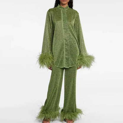 Model wearing the set in olive green glitter, standing front on, with contrast piping down the shirt and feather trim on cuffs and hems. 4