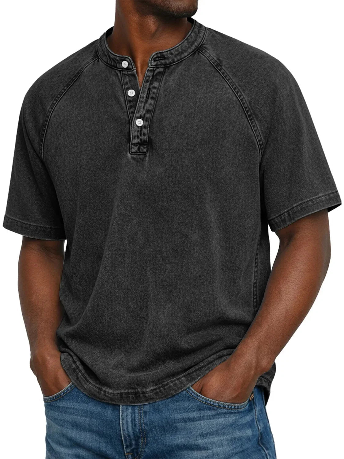 Model wearing the short-sleeved raglan Henley in a washed charcoal black, with stitched raglan seams and a buttoned placket. 5