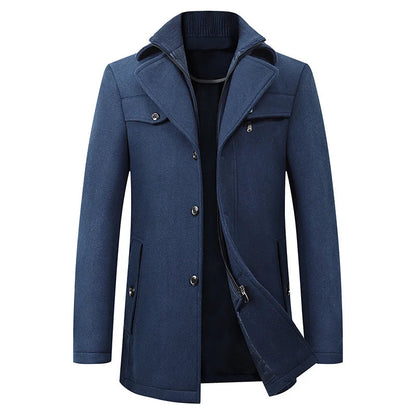 Front view of the blue version, with buttons fastened low and the inner zip layer peeking out beneath the double collar. 3