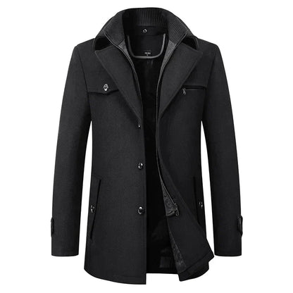 Front view of the black wool-look peacoat with buttoned front, chest and side pockets, and the zip-through inner layer visible at the collar. 1