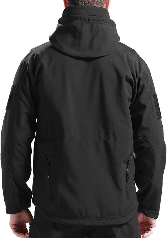 Back view of a man wearing the black hooded jacket, showing the hood, sleeve patches and zipped lower pockets. 7