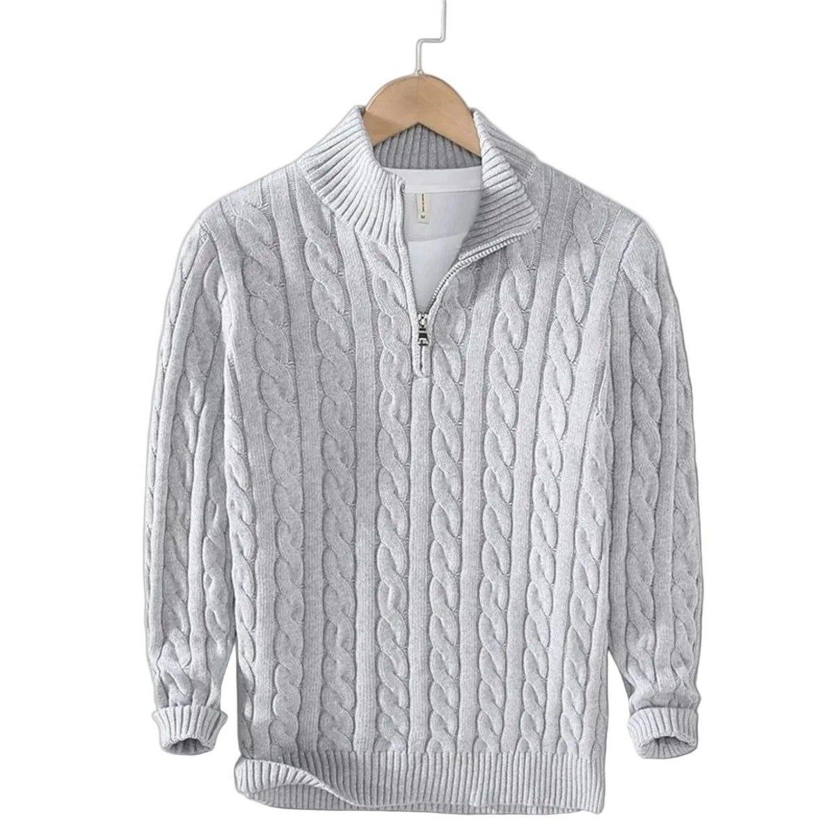 Light grey cable knit jumper with ribbed mock neck and short zip, hanging on a wooden hanger over a white top. 4