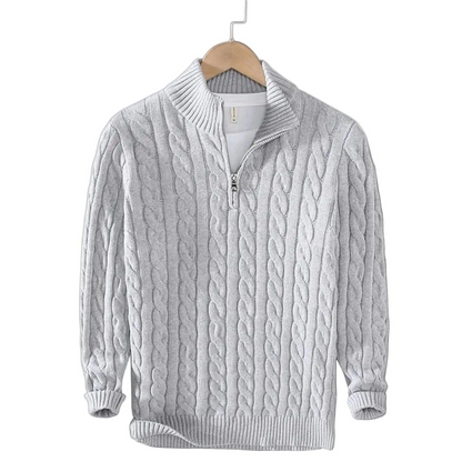 Light grey cable knit jumper with ribbed mock neck and short zip, hanging on a wooden hanger over a white top. 4