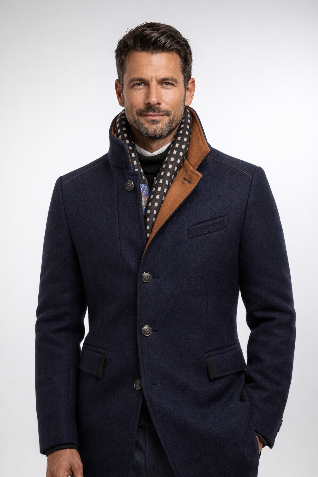 Man wearing the navy coat buttoned, stand collar up, with checked scarf and one hand in pocket 13