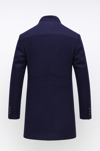 Back view of the navy coat showing panelled seams, a stand collar and three buttons on each cuff 5