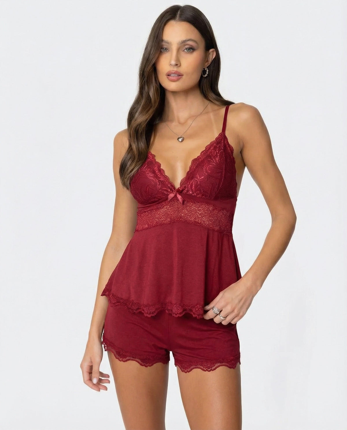 Model wearing the burgundy lace cami and shorts set, front view with a heart necklace 5